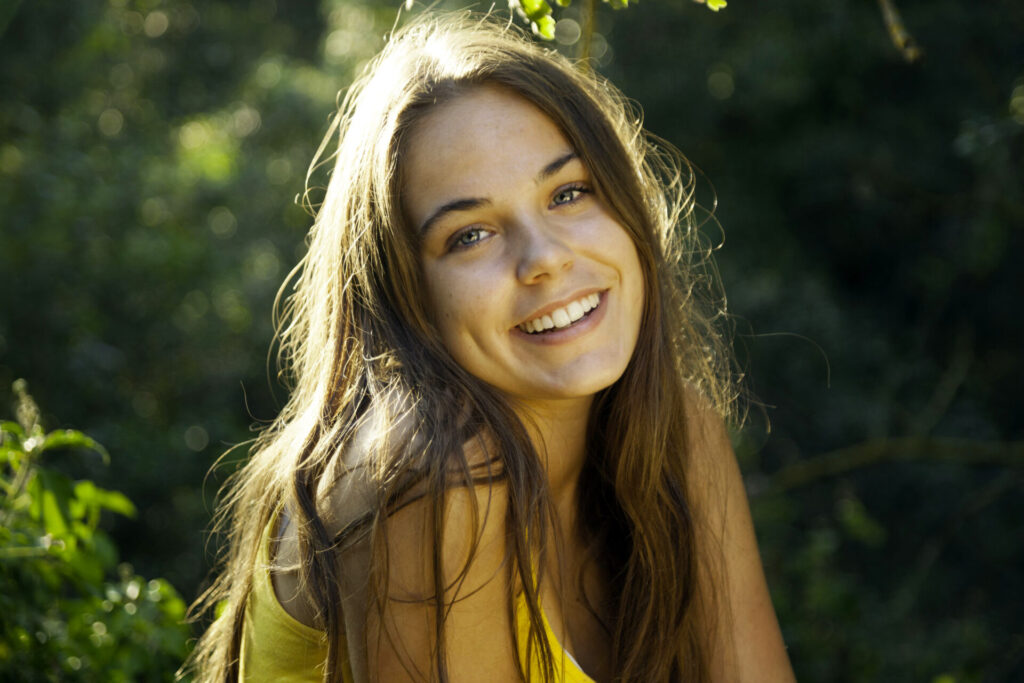 Teenage girl with brown hair smiling