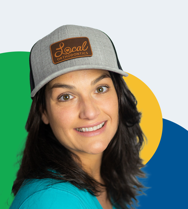 Cutout of a woman, wearing a hat that says local orthodontics